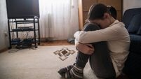 Teen woman with headache holding her head