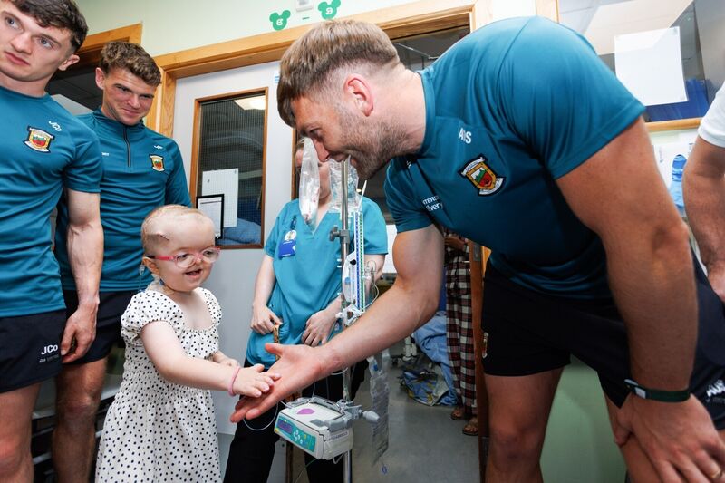 Mayo’s Aidan O’Shea receives a high five from six-year-old patient Darcie Reede from Clontarf as the All-Ireland Senior Football Champions visited Temple St Children’s Hospital on Monday. Picture: Tom Maher/Inpho