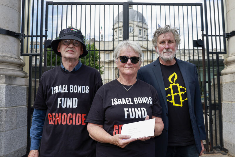 Also today, Sean Marmion and Helen Mahony of the Ireland-Palestine Solidarity Campaign, and Amnesty International Ireland director Stephen Bowen were at Government Buildings where they handed in a letter protesting the Central Bank’s involvement in the sale of Israeli bonds. Picture: Conor Ó Mearáin/Collins Also today, Sean Marmion and Helen Mahony of the Ireland-Palestine Solidarity Campaign, and Amnesty International Ireland director Stephen Bowen were at Government Buildings where they handed in a letter protesting the Central Bank’s involvement in the sale of Israeli bonds. Picture: Conor Ó Mearáin/Collins