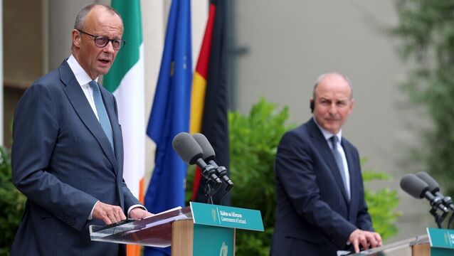 <p>German chancellor Friedrich Merz speaks to members of the media at Farmleigh House as Micheál Martin looks on with what seems to be a quizzical air — as well he might, as the Taoiseach's translation headset had failed. Picture: Liam McBurney/PA</p>
