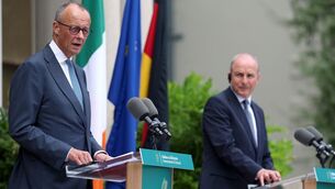 <p>German chancellor Friedrich Merz speaks to members of the media at Farmleigh House as Micheál Martin looks on with what seems to be a quizzical air — as well he might, as the Taoiseach's translation headset had failed. Picture: Liam McBurney/PA</p>