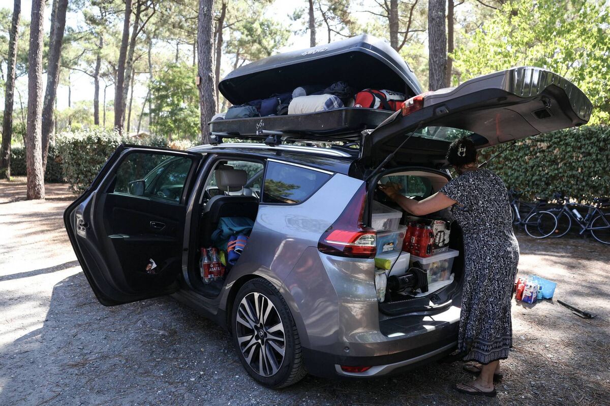 A camper put her belongings into her car as she prepares to evacuate the Lacanau campsite due to a wildfire in the Gironde region in southwestern France on Tuesday. Picture: Alain Jocard/Getty Images