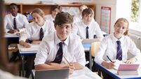 iStock-887303060.jpg Students Listening To Female Teacher In Classroom