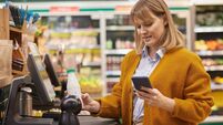 Woman Scanning Groceries at Self Checkout in Supermarket