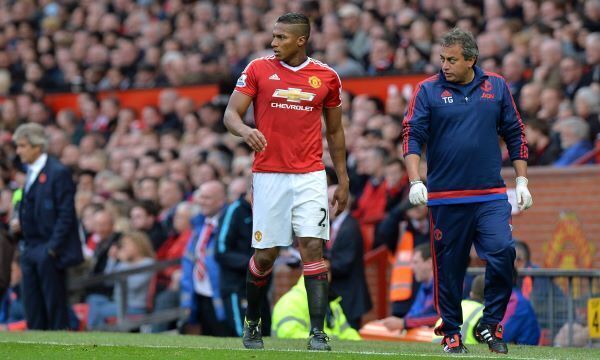 Valencia walks away from the touchline after suffering the injury at Old Trafford.
