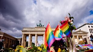 Flowers and rainbow flags placed in front of the Brandenburg Gate (Markus Schreiber/AP) Flowers and rainbow flags placed in front of the Brandenburg Gate (Markus Schreiber/AP)