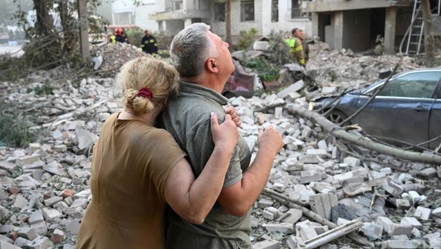 <p>Local residents react outside a residential building partially destroyed as a result of Russian missile strikes in the western Ukrainian city of Lviv on July 30, 2026, amid the Russian invasion in Ukraine. Picture: YURIY DYACHYSHYN / AFP via Getty Images</p>