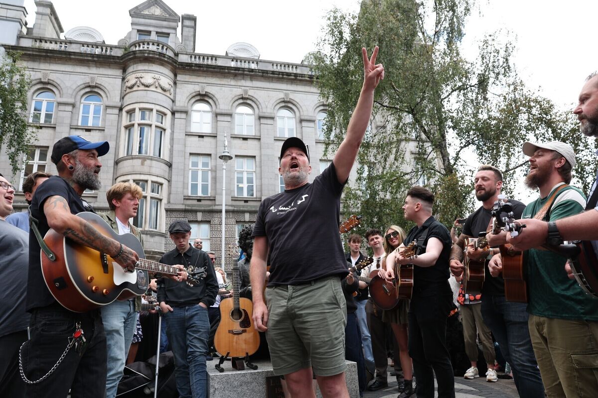 Dean Scurry joins musicians as they remember Glen Hansard on King Street in Dublin. Picture: Damien Eagers/PA Dean Scurry joins musicians as they remember Glen Hansard on King Street in Dublin. Picture: Damien Eagers/PA