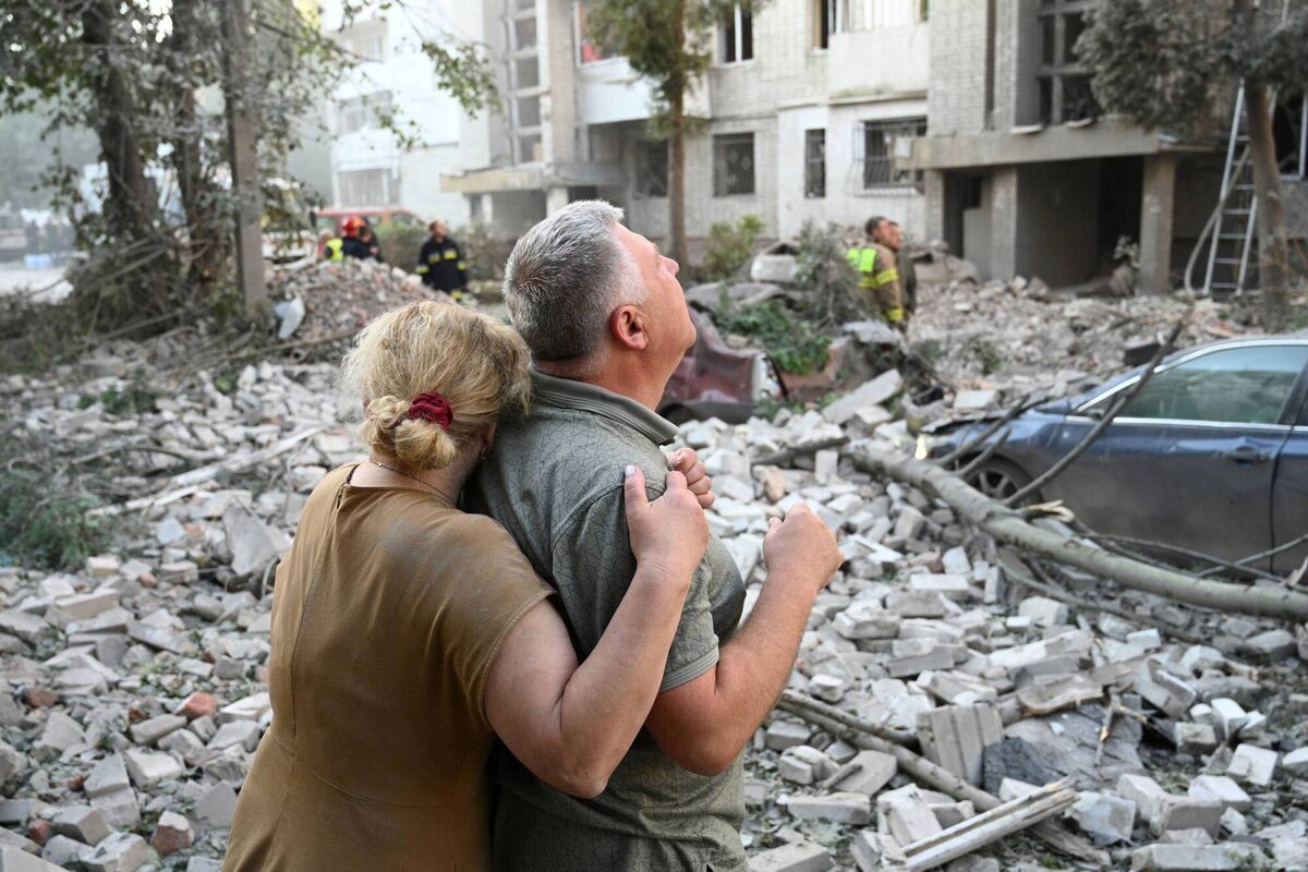 Distressed residents outside an apartment building partially destroyed by Russian missile strikes in the western Ukrainian city of Lviv yesterday, July 30. Picture: Yuriy Dyachyshyn/AFP/Getty
