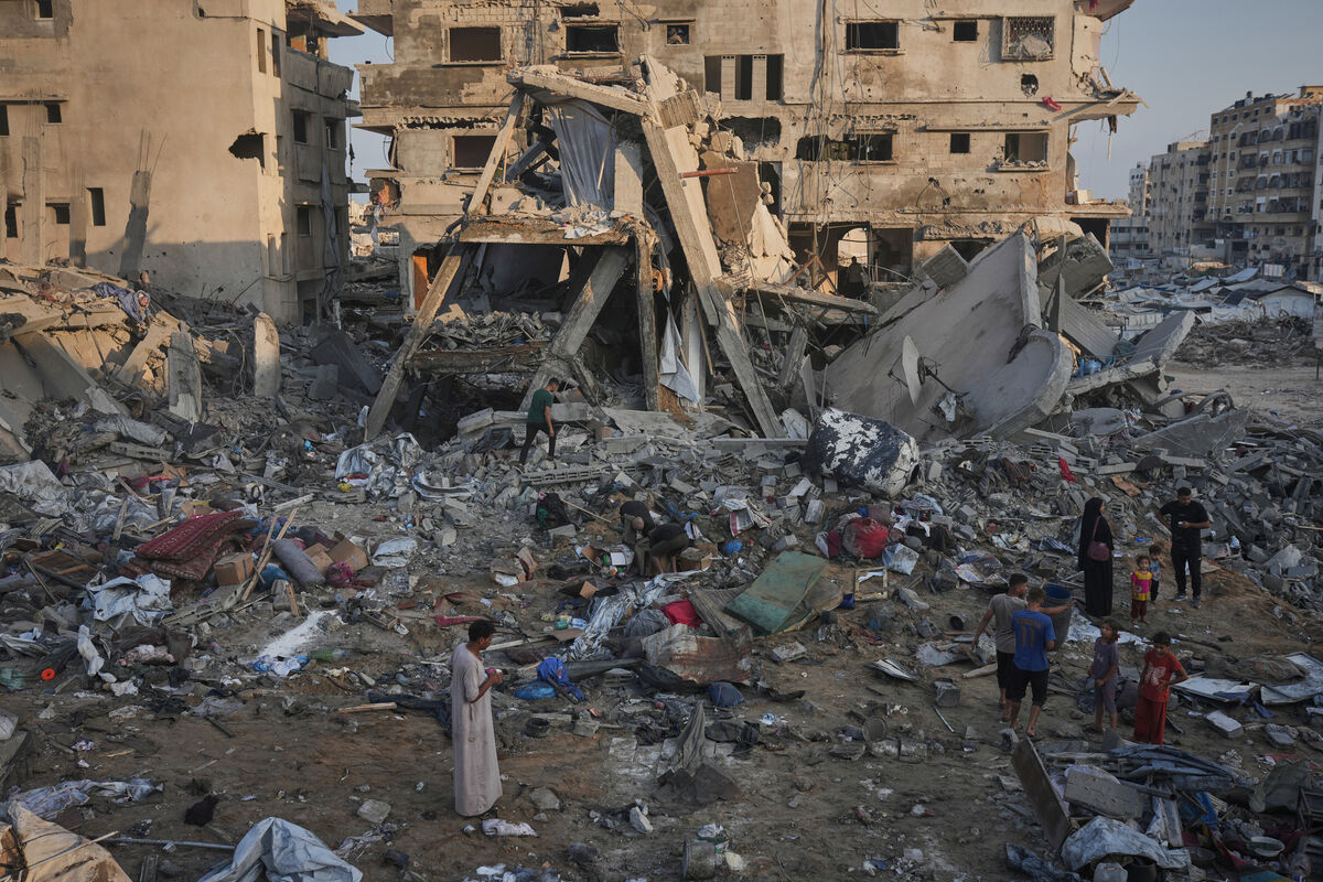 Palestinians salvage their belongings from the rubble of a building and tents destroyed in an Israeli airstrike in Gaza City (Jehad Alshrafi/AP) Palestinians salvage their belongings from the rubble of a building and tents destroyed in an Israeli airstrike in Gaza City (Jehad Alshrafi/AP)