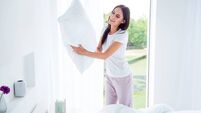 Daily home work routine. Charming beautiful nice stylish brunette girl doing everyday house work, householding, changing fresh c