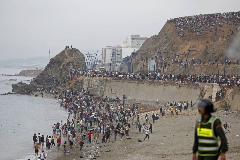 People gather along the fence at the site of clashes near Fnideq, on the Morocco-Spain border, on July 31, 2026. Picture: Abdel Majid BZIOUAT / AFP via Getty Images People gather along the fence at the site of clashes near Fnideq, on the Morocco-Spain border, on July 31, 2026. Picture: Abdel Majid BZIOUAT / AFP via Getty Images