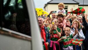 <p>READY TO BURST: Supporters cheer the Mayo team bus on the way to the homecoming celebrations at Hastings Insurance MacHale Park in Castlebar. Pic: Piaras Ó Mídheach/Sportsfile</p>