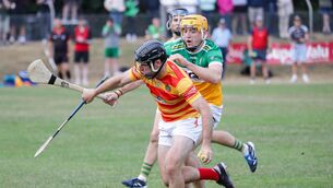 <p>Newcestown's Colm Dinneen tries to get away from Bride Rovers Cillian Tobin. Pic: David Creedon</p>