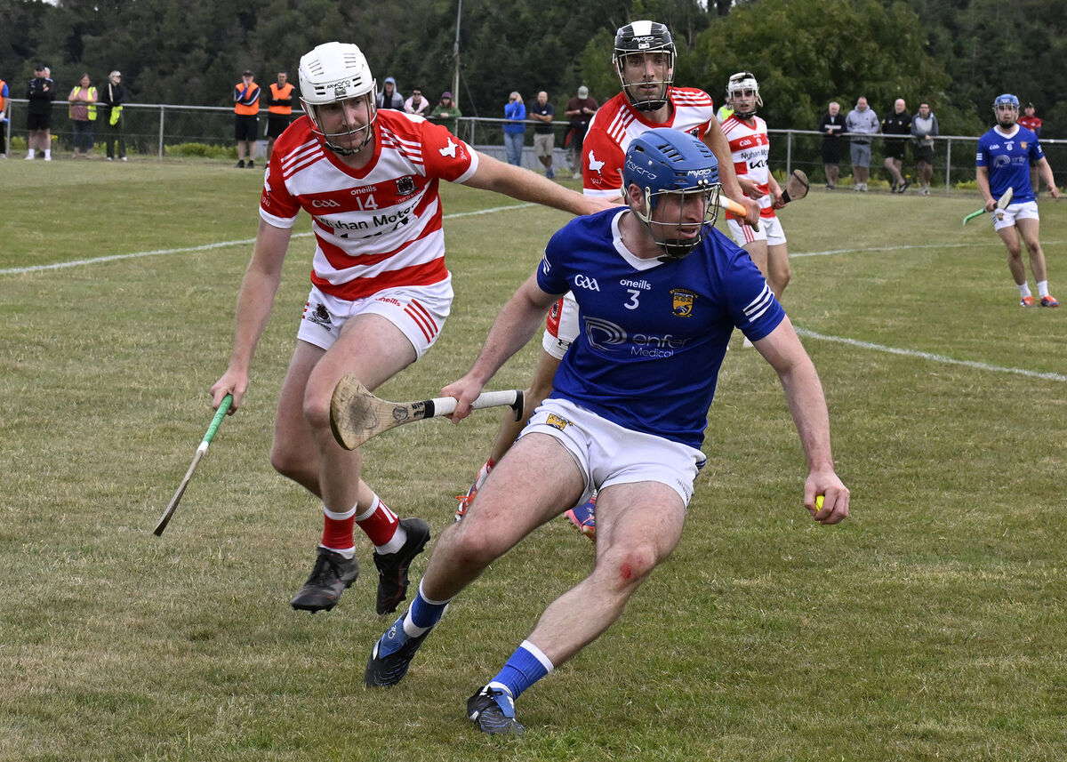 Charlie Grainger (Ballinhassig) clears away from Richard Sweeetnam (Courcey Rovers). Pic: Martin Walsh Charlie Grainger (Ballinhassig) clears away from Richard Sweeetnam (Courcey Rovers). Pic: Martin Walsh