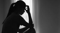 iStock-1589667733.jpg Young women sitting in dark room feeling pain with life problem. suffering from husband violence, Stop violence against and se