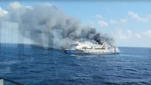 Smoke billows from passenger ship Mutiara Sentosa 2 after it caught fire in the waters off Madura Island, Indonesia (Basarnas via AP)