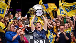 <p>CHAMPIONS: Helena Cummins lifts the Mary Quinn Memorial Cup after Roscommon were crowned All Ireland Intermediate LGFA champions for the first time since 2005. Picture: INPHO/Ben Brady</p>