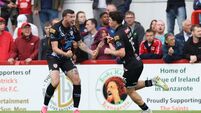 James Clarke celebrates after scoring his side's first goal of the match with Patrick McClean 2/8/2026