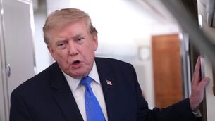 President Donald Trump speaks to reporters onboard Air Force One (Jacquelyn Martin/AP)