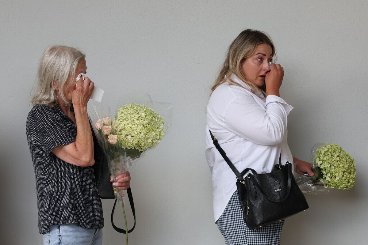 People wipe tears with tissue whilst queueing to attend a public wake for Glen Hansard at the Irish Museum of Modern Art (IMMA) in Dublin. Photo: Damien Eagers/PA Wire