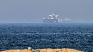 Cargo ships are seen at sea near the Strait of Hormuz (Fatima Shbair/AP) Cargo ships are seen at sea near the Strait of Hormuz (Fatima Shbair/AP)