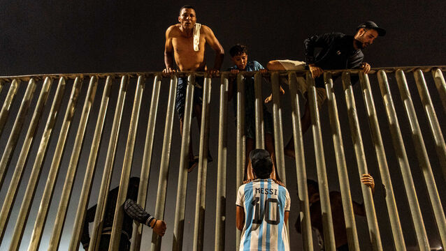 <p>Migrants try to cross from Morocco into the Spanish enclave of Ceuta on Friday. Photo: AP/Antonio Sempere</p>