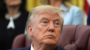 President Donald Trump listens during a meeting about military families, in the Oval Office (Alex Brandon/AP)