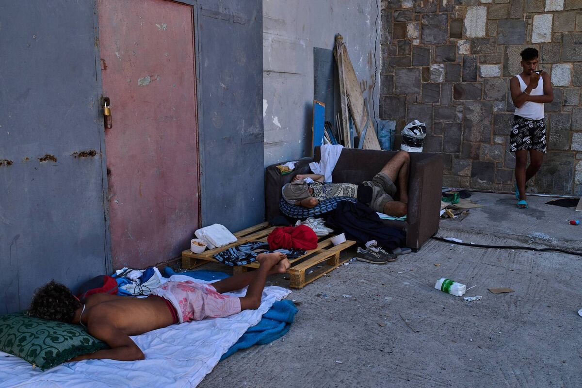 Migrants who crossed from Morocco into Spain sleep in a warehouse area near the Spain-Morocco border in the Spanish enclave of Ceuta, Monday, Aug. 3, 2026. (AP Photo/Bernat Armangue)