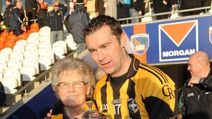 <p>Oisin McConville celebrates with his mother Margaret McConville after Crossmaglen Rangers won the 2011 Armagh SFC final. Pic: Oliver McVeigh / SPORTSFILE</p>