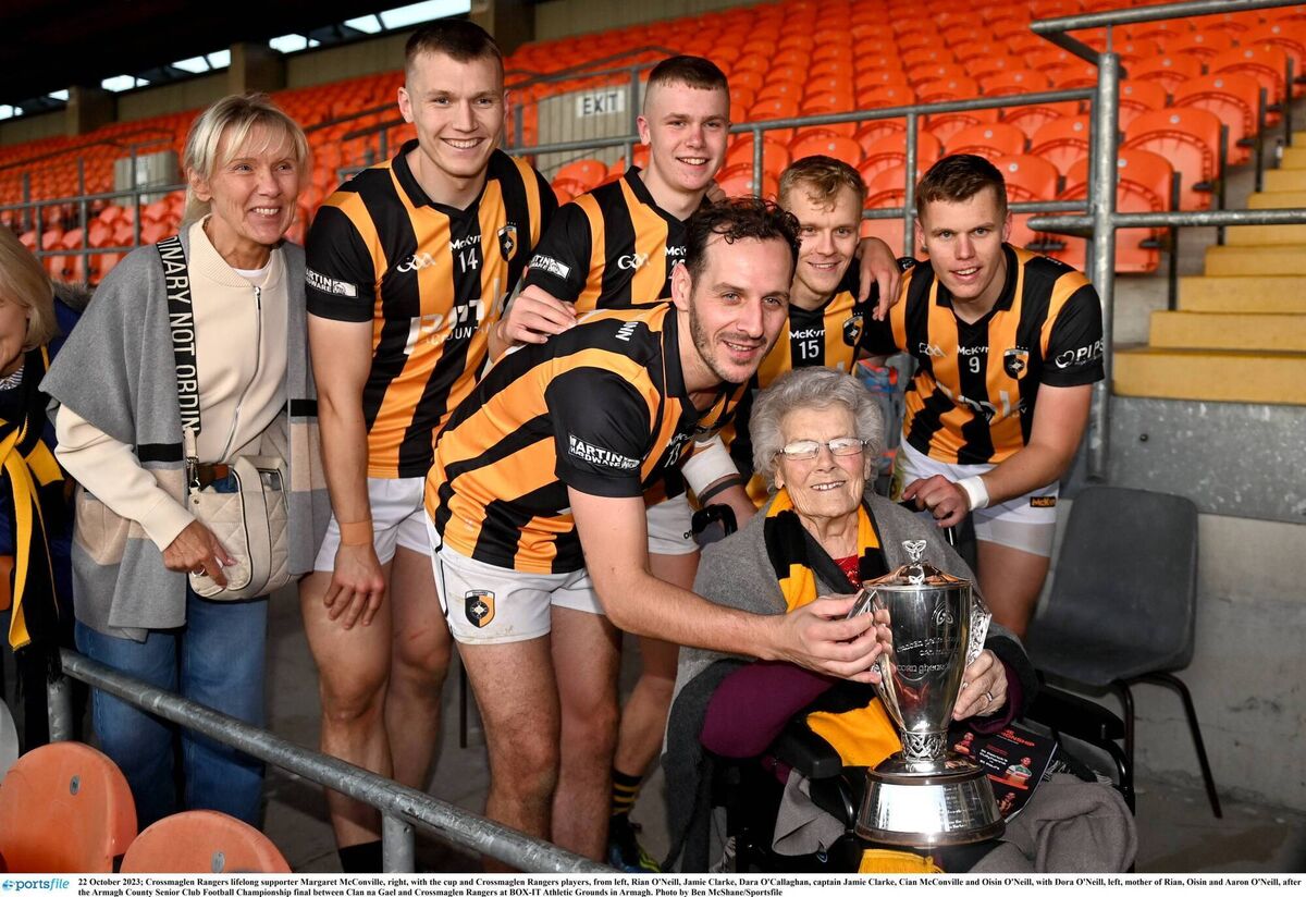 Crossmaglen Rangers lifelong supporter Margaret McConville, right, with the cup and Crossmaglen Rangers players, from left, Rian O'Neill, Jamie Clarke, Dara O'Callaghan, captain Jamie Clarke, Cian McConville and Oisin O'Neill, with Dora O'Neill, left, mother of Rian, Oisin and Aaron O'Neill, after 2023 Armagh SFC final. Pic: Ben McShane/Sportsfile Crossmaglen Rangers lifelong supporter Margaret McConville, right, with the cup and Crossmaglen Rangers players, from left, Rian O'Neill, Jamie Clarke, Dara O'Callaghan, captain Jamie Clarke, Cian McConville and Oisin O'Neill, with Dora O'Neill, left, mother of Rian, Oisin and Aaron O'Neill, after 2023 Armagh SFC final. Pic: Ben McShane/Sportsfile