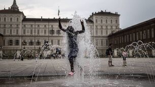 <p>A young girl cools off in a public fountain in Piazza Castello during a heatwave in Turin, Italy, this week. Picture: Marco Bertorello/Getty Images</p>