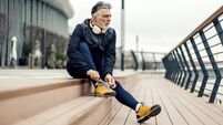Mature man tying shoelace preparing for urban jog