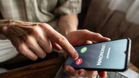 Senior man refuses to answer to a call from unknown number. Scam and fraud prevention with smartphone concept.