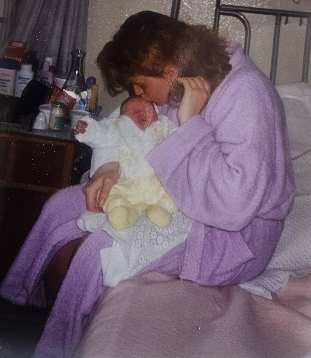 Nóra Flaherty cradling her baby daughter Aoife in St Finbarr's Hospital in May 1993. Aoife is wearing the yellow suit Nóra knitted for her in Bessborough. Nóra Flaherty cradling her baby daughter Aoife in St Finbarr's Hospital in May 1993. Aoife is wearing the yellow suit Nóra knitted for her in Bessborough.