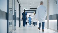 Hospital Hallway with Doctors, Nurses and Specialists in Hospital. Female and Male Physicians, Surgeons, Healthcare Officials Wa