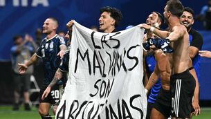 <p>OBSESSION: Argentina's players hold a banner reading "The Malvinas (Falkland Islands) belong to Argentina," after victory in the World Cup semi final over England. Pic: Paul Ellis/Getty</p>