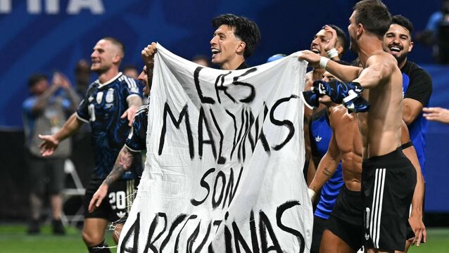 <p>OBSESSION: Argentina's players hold a banner reading "The Malvinas (Falkland Islands) belong to Argentina," after victory in the World Cup semi final over England. Pic: Paul Ellis/Getty</p>