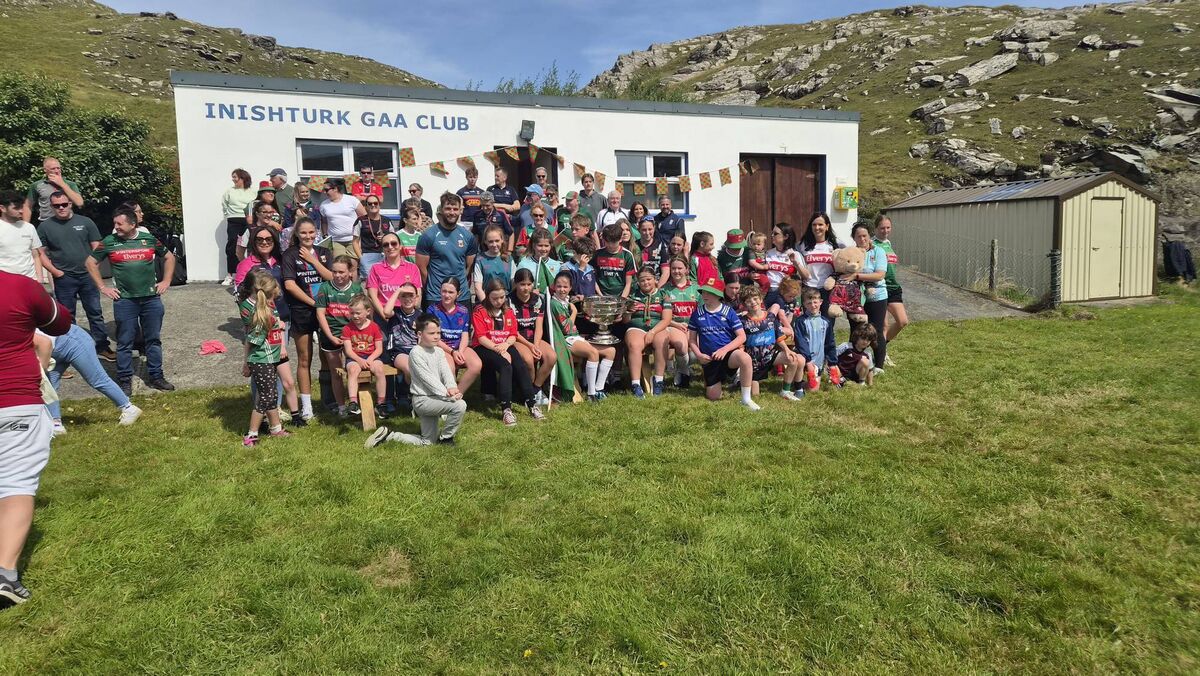 WELCOMING COMMITTEE: The natives and future stars of Inishturk GAA welcome Aidan O'Shea, Jack Carney and Sam Maguire to the island on Thursday. WELCOMING COMMITTEE: The natives and future stars of Inishturk GAA welcome Aidan O'Shea, Jack Carney and Sam Maguire to the island on Thursday.
