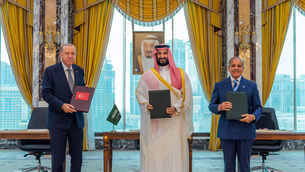 Turkish President Recep Tayyip Erdogan, Saudi Crown Prince Mohammed bin Salman and Pakistani Prime Minister Shehbaz Sharif pose after signing a trilateral defence agreement in Mecca, Saudi Arabia (Saudi Press Agency/AP)