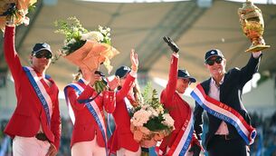 <p>Team USA members, from left, Karl Cook, Natalie Dean, Robert Ridland, Laura Kraut and Paris Sellon celebrate with the Aga Khan trophy. Pic: Shauna Clinton/Sportsfile</p>
