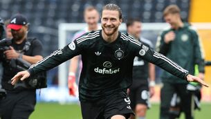 <p>Celtic's Kasper Hogh celebrates in front of the fans after the final whistle in the William Hill Premiership match at BBSP Stadium Rugby Park, Kilmarnock. </p>