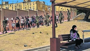 <p>Spanish soldiers escort migrants back to the Moroccan border past a resident at a bus stop in Ceuta. While the arrival of so many people was an issue, a wave of social media posts omitted to mention that most of the migrants returned to Morocco within days. Picture: Bernat Armangue/AP</p> <p>Spanish soldiers escort migrants back to the Moroccan border past a resident at a bus stop in Ceuta. While the arrival of so many people was an issue, a wave of social media posts omitted to mention that most of the migrants returned to Morocco within days. Picture: Bernat Armangue/AP</p>