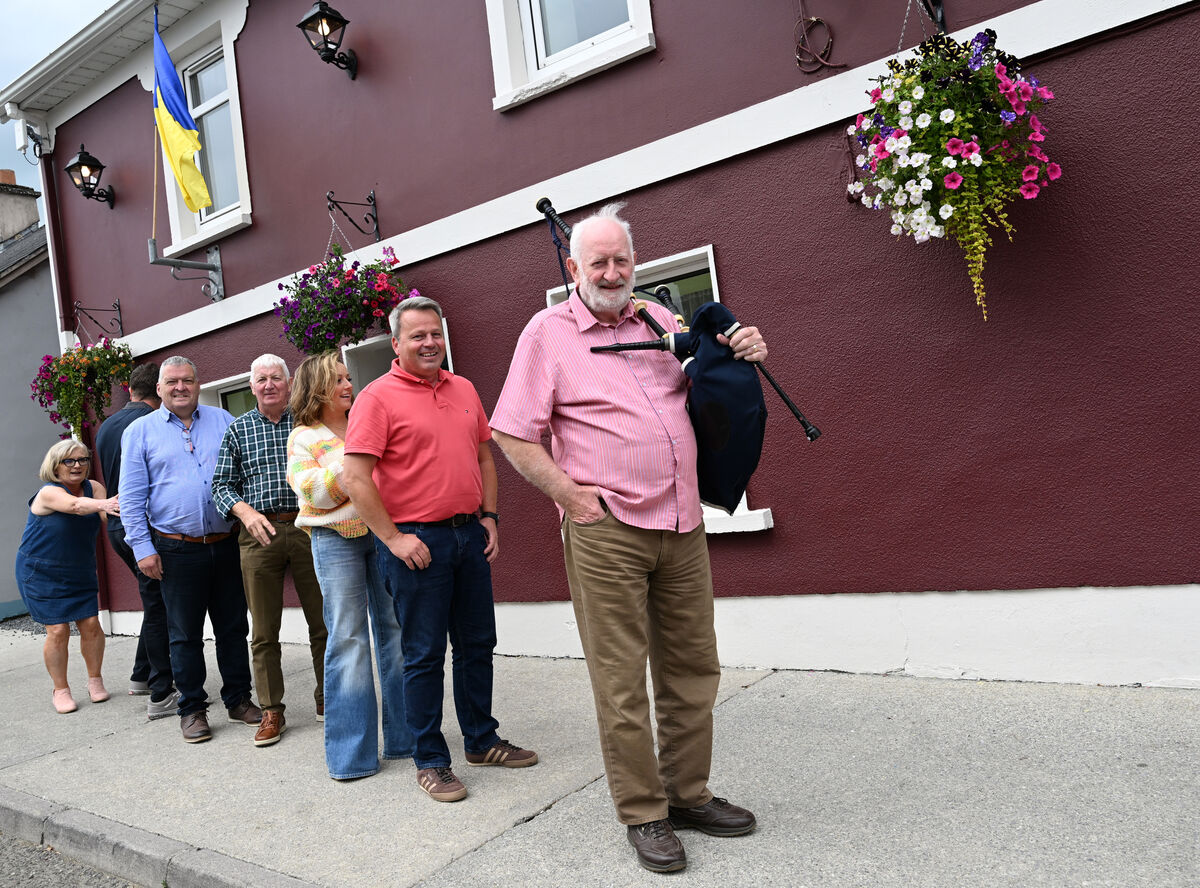 Piper Con Houlihan leading customers into Tigh Laitiarain (Laiti's) in Cullen, Co Cork. The local community came together to buy the premises and re-open the pub. Picture: Larry Cummins