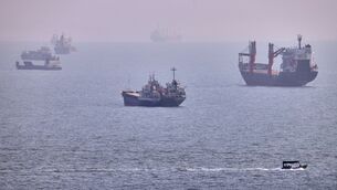 A small boat sails past cargo ships and other commercial vessels anchored in the Strait of Hormuz off Bandar Abbas, Iran (Amirhosein Khorgooi/ISNA/AP) A small boat sails past cargo ships and other commercial vessels anchored in the Strait of Hormuz off Bandar Abbas, Iran (Amirhosein Khorgooi/ISNA/AP)