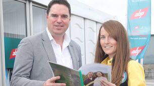<p>Minister Martin Heydon with Carina Roseingrave, female farm ambassador for the international year of the female farmer holding the Gender-Inclusive Communications Guide which was launched on Sunday at the Tullamore Show. Picture: Maxwells</p>