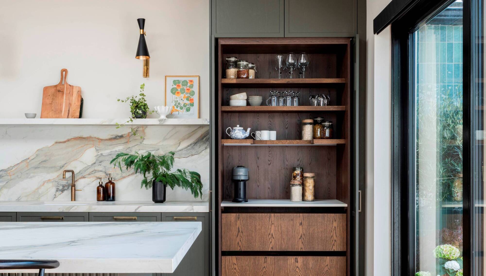 A stunning bespoke pantry cupboard in gorgeous timber laminates from Noel Dempsey Kitchens (Dublin) curates a coffee lover's collection and offers oodles of extra storage. Pantries and built-in barista areas can be used for anything from working over a short desk to pastry-making.