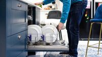 Open Dishwasher Filled With Dirty Plates