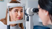 Eye doctor with female patient during an examination in modern clinic