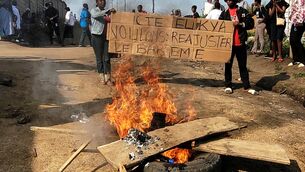 <p>Rubble set on fire as health and frontline workers protest at the Elikya Ebola Treatment Center in Bunia, Congo, on Saturday, July 25, 2026. (AP Photo/Constant Same Bagalwa)</p>